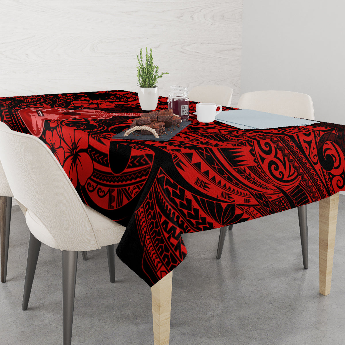Red and black Polynesian-pattern tablecloth with ukulele motif on dining table