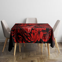 Red and black Polynesian-pattern tablecloth with ukulele print on square table