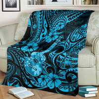 Hawaiian ukulele blanket draped over sofa, sky blue swirl design with ukulele guitar motifs