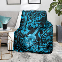 Hawaiian ukulele blanket on couch, sky blue hibiscus and ukulele pattern with dark accents