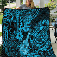 Blue Polynesian ukulele quilt blanket with black background and swirling tiki guitar pattern
