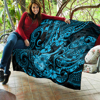 Blue Polynesian ukulele quilt blanket held on patio, black background with tiki guitar graphic