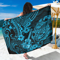 Blue Polynesian sarong with teal floral and tribal swirls, shown draped