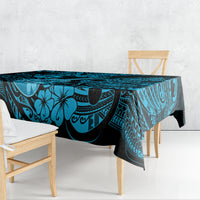 Blue Polynesian tablecloth draped over dining table, with palm and swirl design