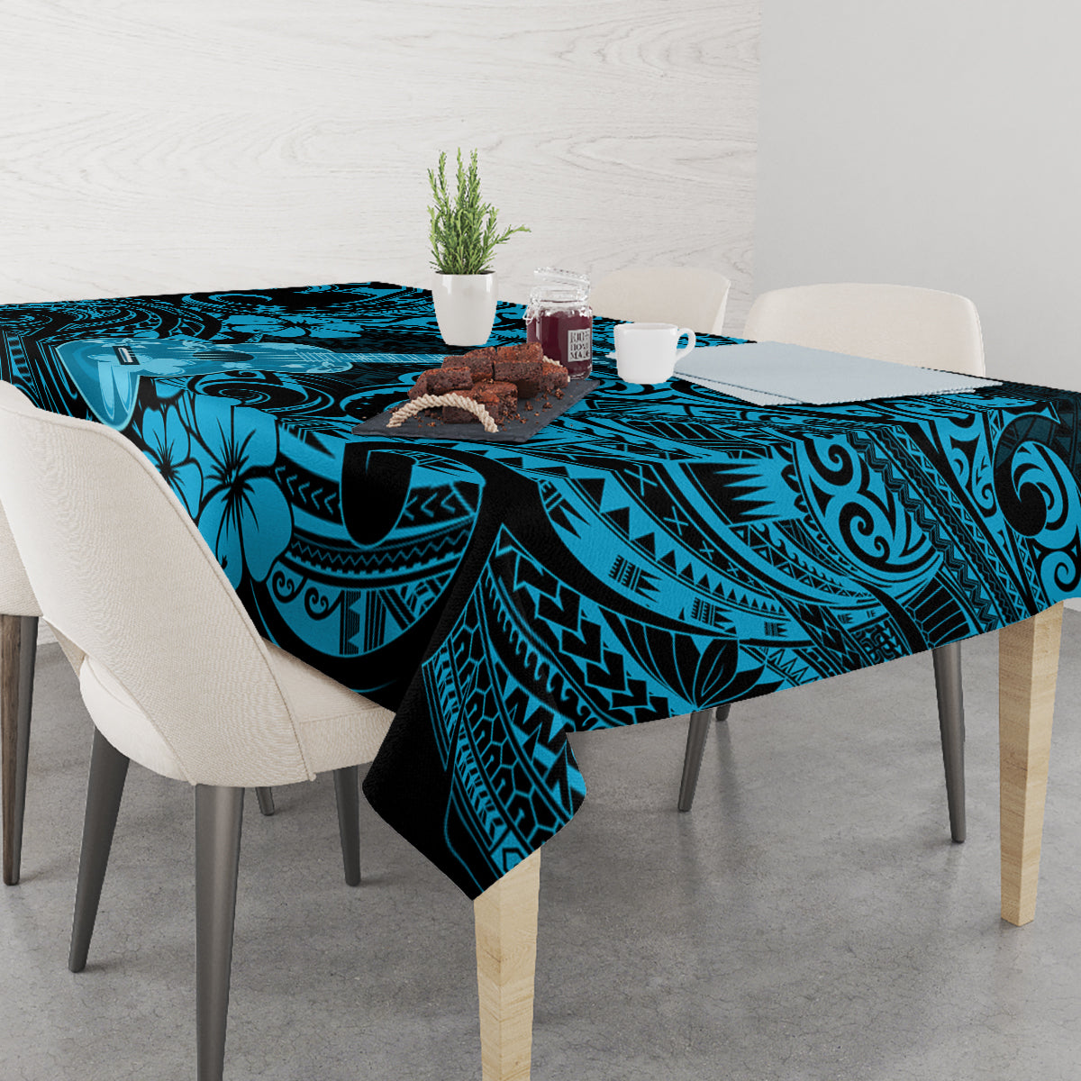 Blue Polynesian tablecloth on dining table with tiki scallops and floral motifs