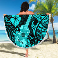Turquoise round beach blanket with tassel fringe, Polynesian ukulele pattern worn on beach