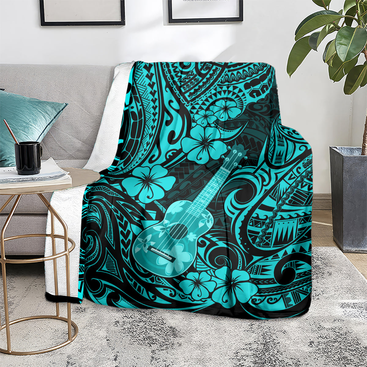 Turquoise Polynesian ukulele blanket over a couch arm with hibiscus flowers and swirls