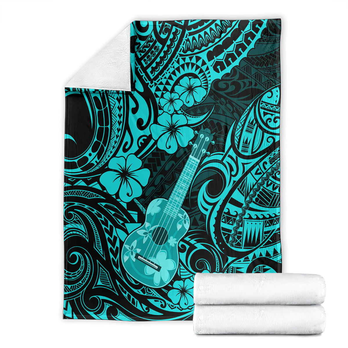 Turquoise Polynesian ukulele blanket with floral and wave patterns beside folded white towels