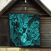 Turquoise Polynesian pattern quilt hanging indoors with ukulele motif and swirl accents