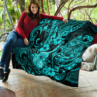 Turquoise Polynesian pattern quilt draped on a couch cushion with ukulele center