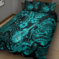Turquoise and black quilt bed set with floral and swirl patterns, on bed with pillows
