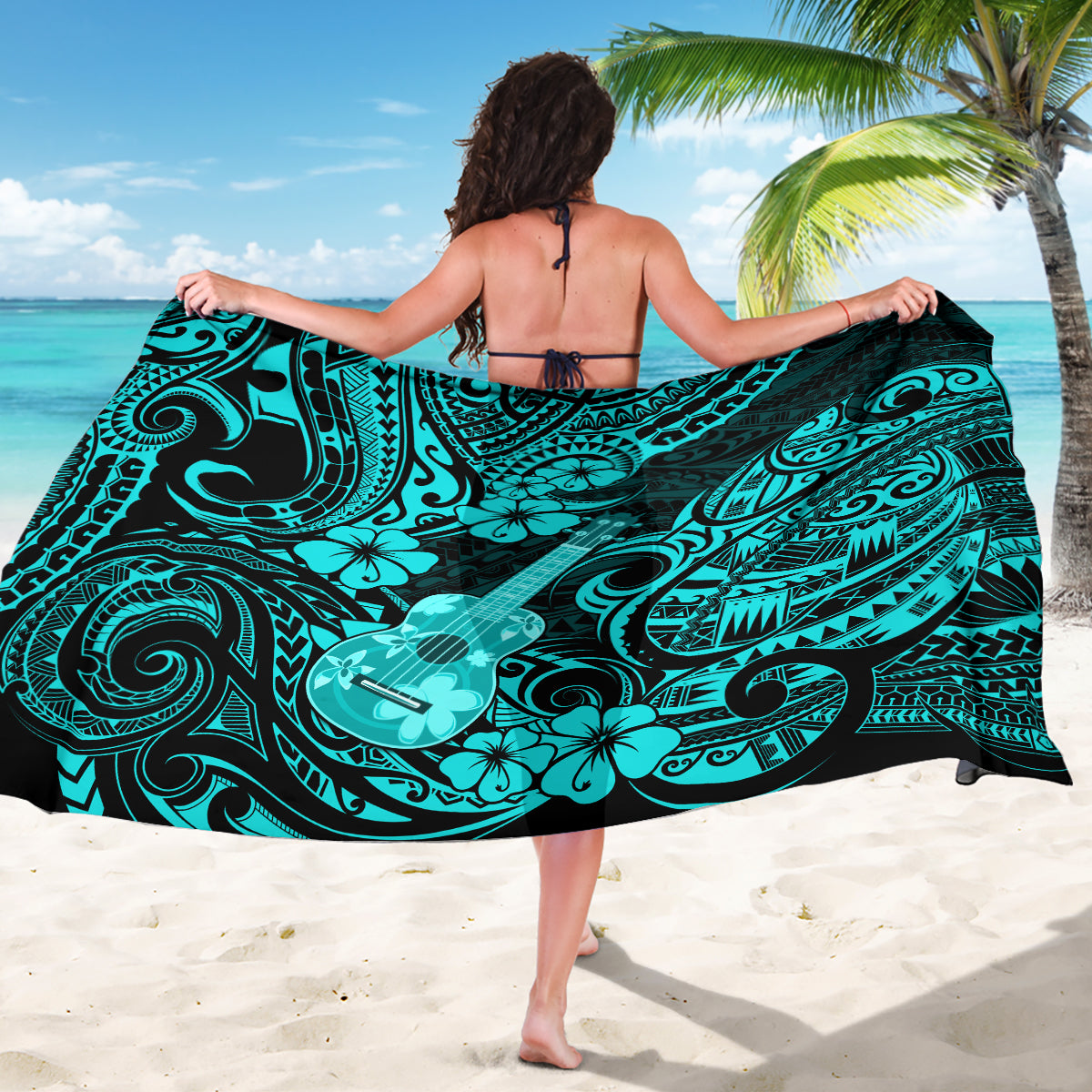 Turquoise polynesian print sarong spread wide, featuring swirling motifs and guitar design