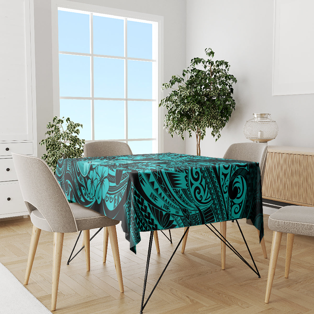 Turquoise tablecloth on long dining table with black tribal wave and flower motifs
