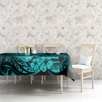 Turquoise tablecloth on table with black tiki floral swirls and curved patterns