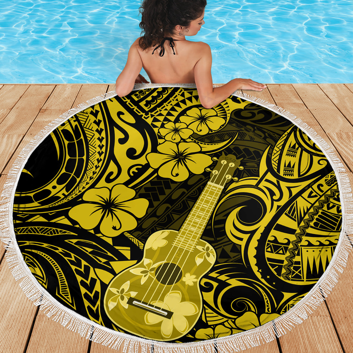 Round yellow beach blanket with fringed border and bold black ukulele floral pattern