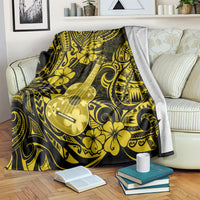 Polynesian ukulele blanket with yellow hibiscus and ukulele motif, tossed over sofa