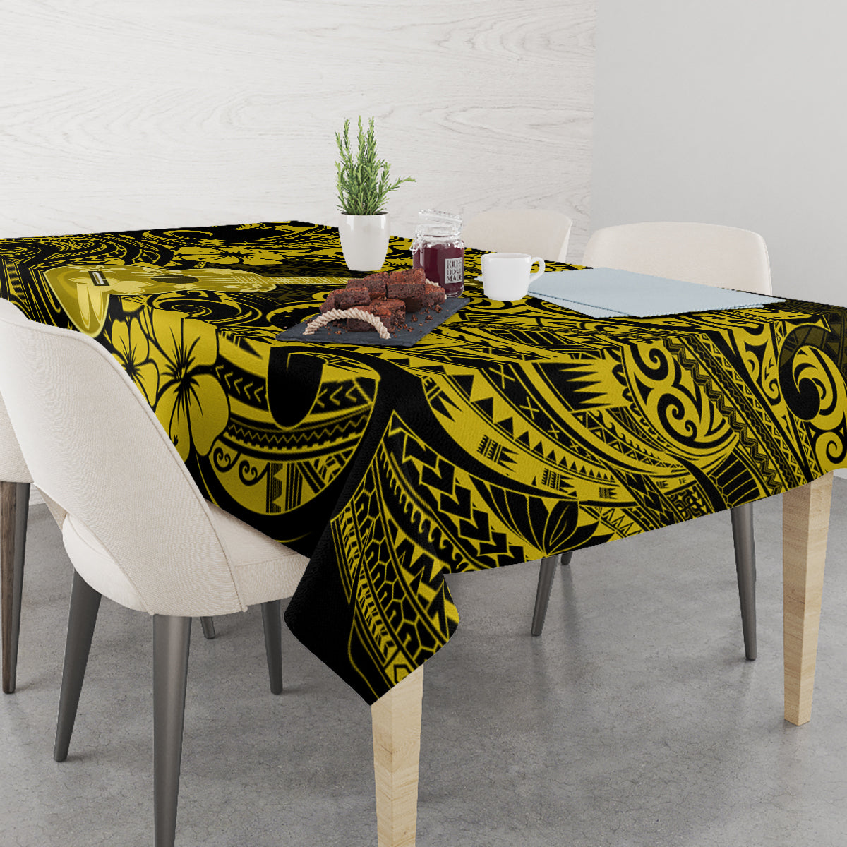 Yellow and black patterned tablecloth on dining table with flower and swirl motifs