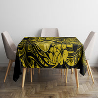 Yellow and black patterned tablecloth with floral, sun-like emblems and swirls
