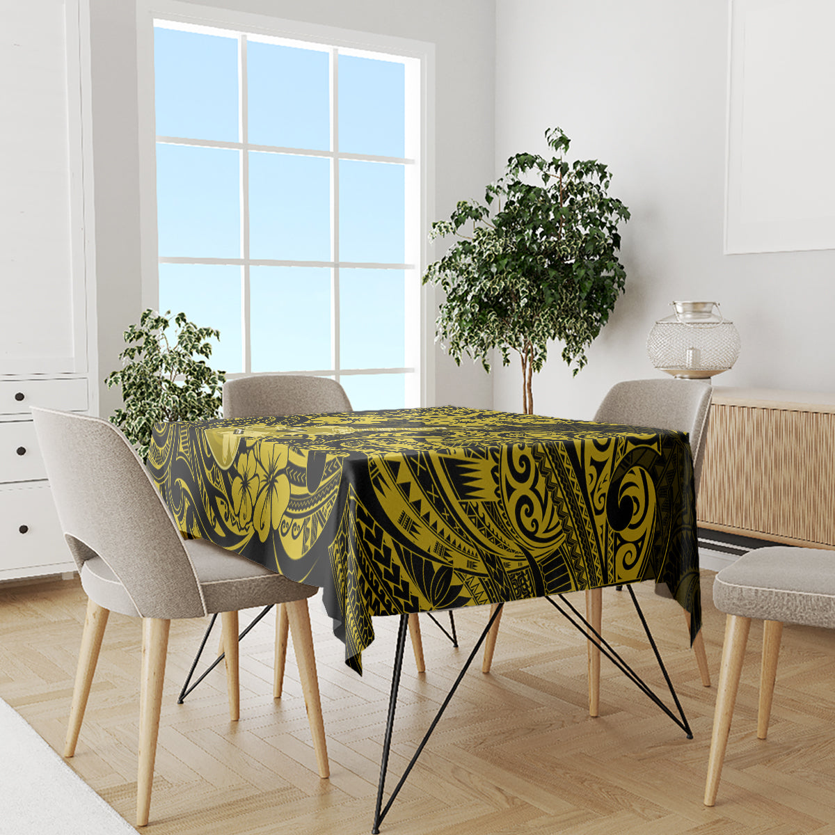 Yellow and black patterned tablecloth with tropical leaf motifs and ornamental swirls