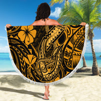 Round gold and black Polynesian pattern beach blanket with white fringed edge, held up