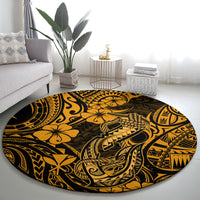 Round gold-and-black Polynesian fish hook patterned carpet in living room layout.