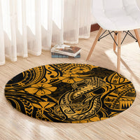 Round gold-and-black Polynesian fish hook patterned carpet under a chair.