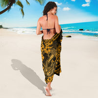 Gold and black Polynesian patterned sarong wrap skirt with fish-hook and floral swirls