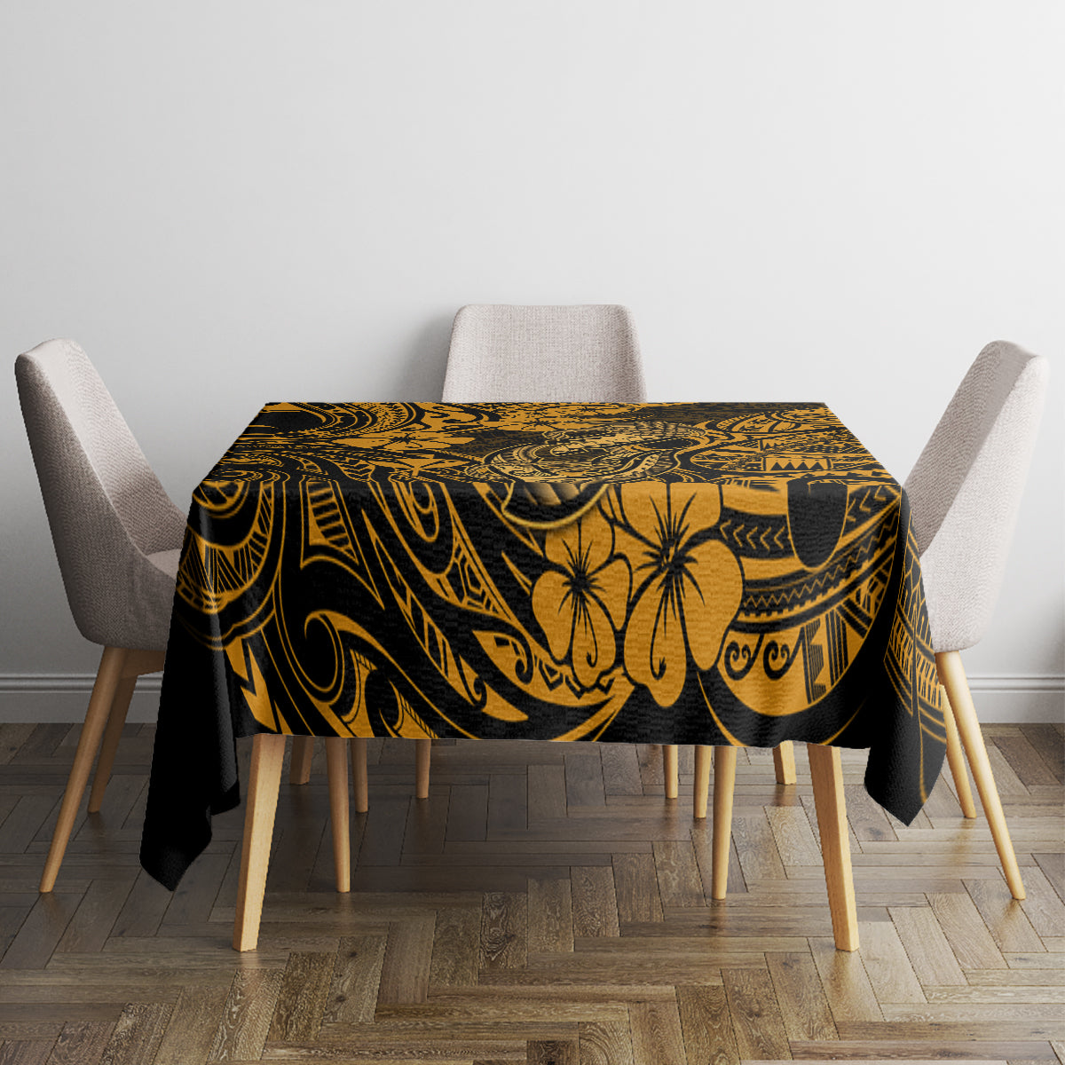 Black tablecloth with gold Polynesian-style floral and swirl pattern on a rectangular tabletop.