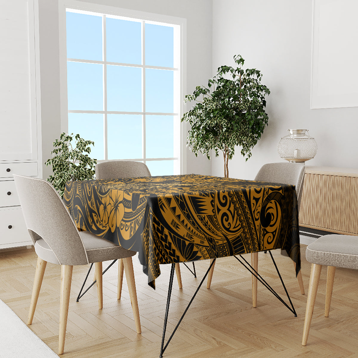 Tablecloth with dark background and gold Polynesian motifs, neatly draped across a dining table.