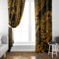 Gold and black Polynesian-pattern window curtains hanging on each side of a doorway