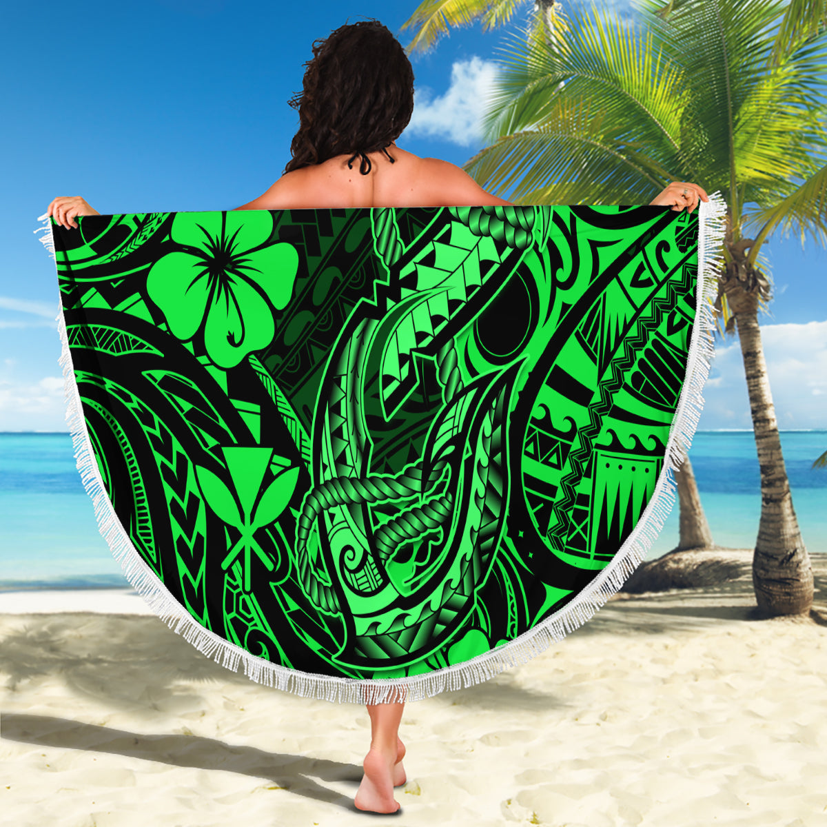 Round green Polynesian-pattern beach blanket with white fringe, held up