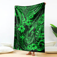 Green Polynesian fish hook blanket with black and neon-green tribal patterns, draped