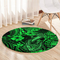 Round green Polynesian fishhook pattern area rug on light wood floor, circular edge design.