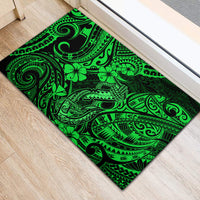 Green rubber doormat with bold Polynesian fish hook and floral motifs, rectangular