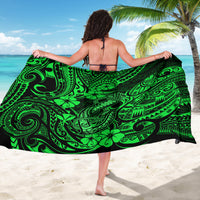 Green polynesian fish-hook sarong with swirl and leaf print, back-tied with black edges