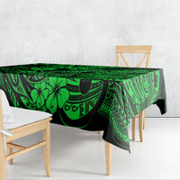 Green Polynesian tablecloth with bold tribal shapes and hook-style fish motif, draped
