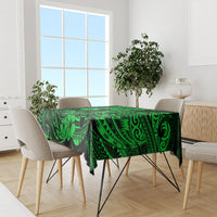 Green Polynesian tablecloth with fish hook motif and leafy tribal pattern, skirted