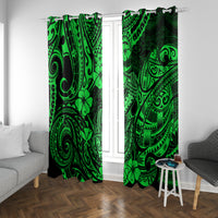 Green Polynesian patterned window curtain panels, two sides framing glass door and sofa