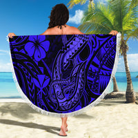 Round navy Polynesian fish hook beach blanket with fringe edge, held open as wrap