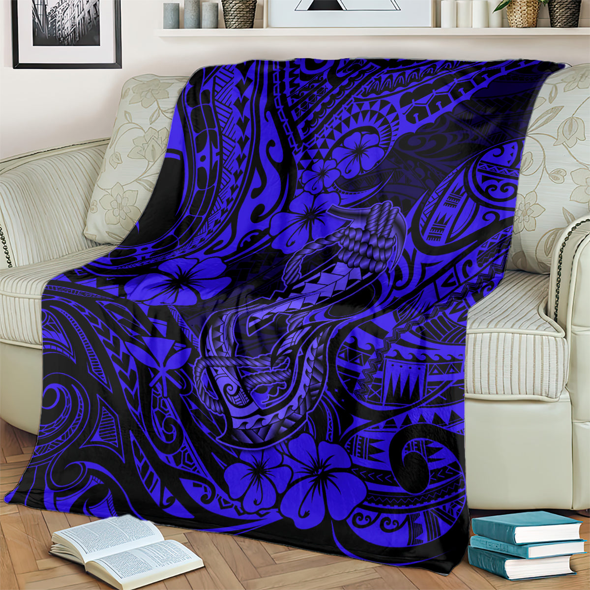 Navy blue blanket with blue fish hook and floral tribal motifs, covering a sofa seat