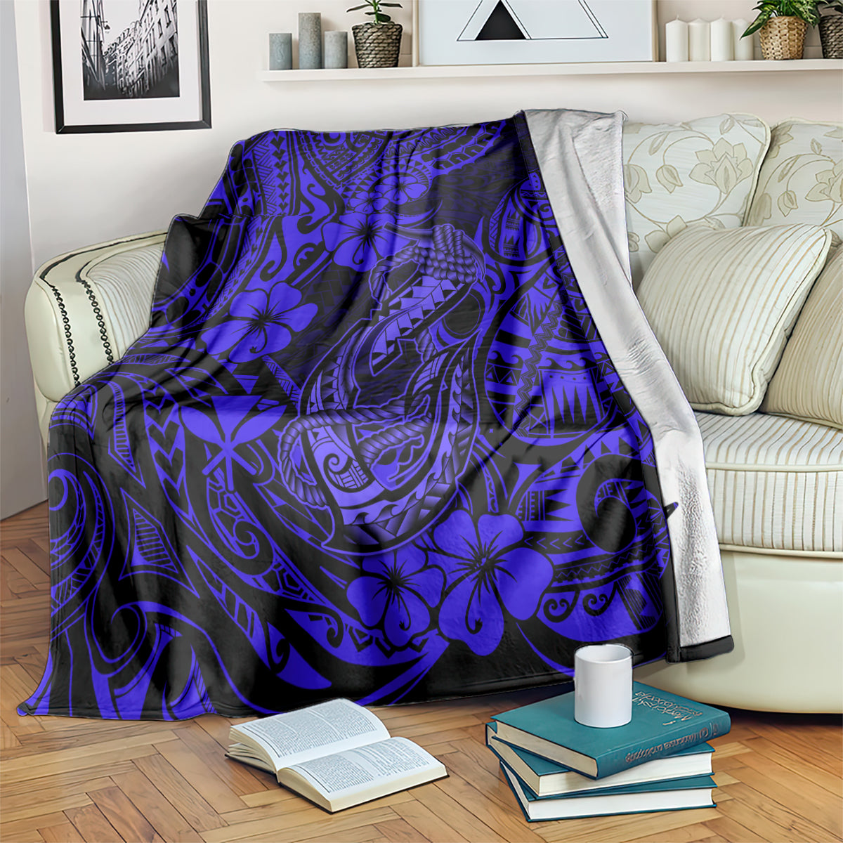 Navy blue fish hook blanket with blue floral and tribal motifs, neatly spread over couch