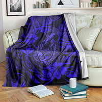 Navy blue fish hook blanket with blue floral and tribal motifs, neatly spread over couch