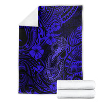 Navy blue fish hook blanket with blue tribal floral motifs, folded with rolled towels