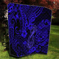 Navy patterned quilt blanket with Polynesian fish-hook swirls and hibiscus flowers