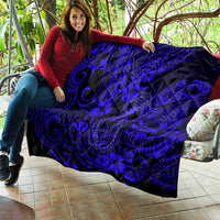 Navy quilt blanket with Polynesian fish-hook swirls and hibiscus floral motifs