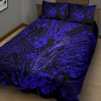 Navy blue patterned quilt with Polynesian fish-hook motifs and floral swirls, two pillow shams