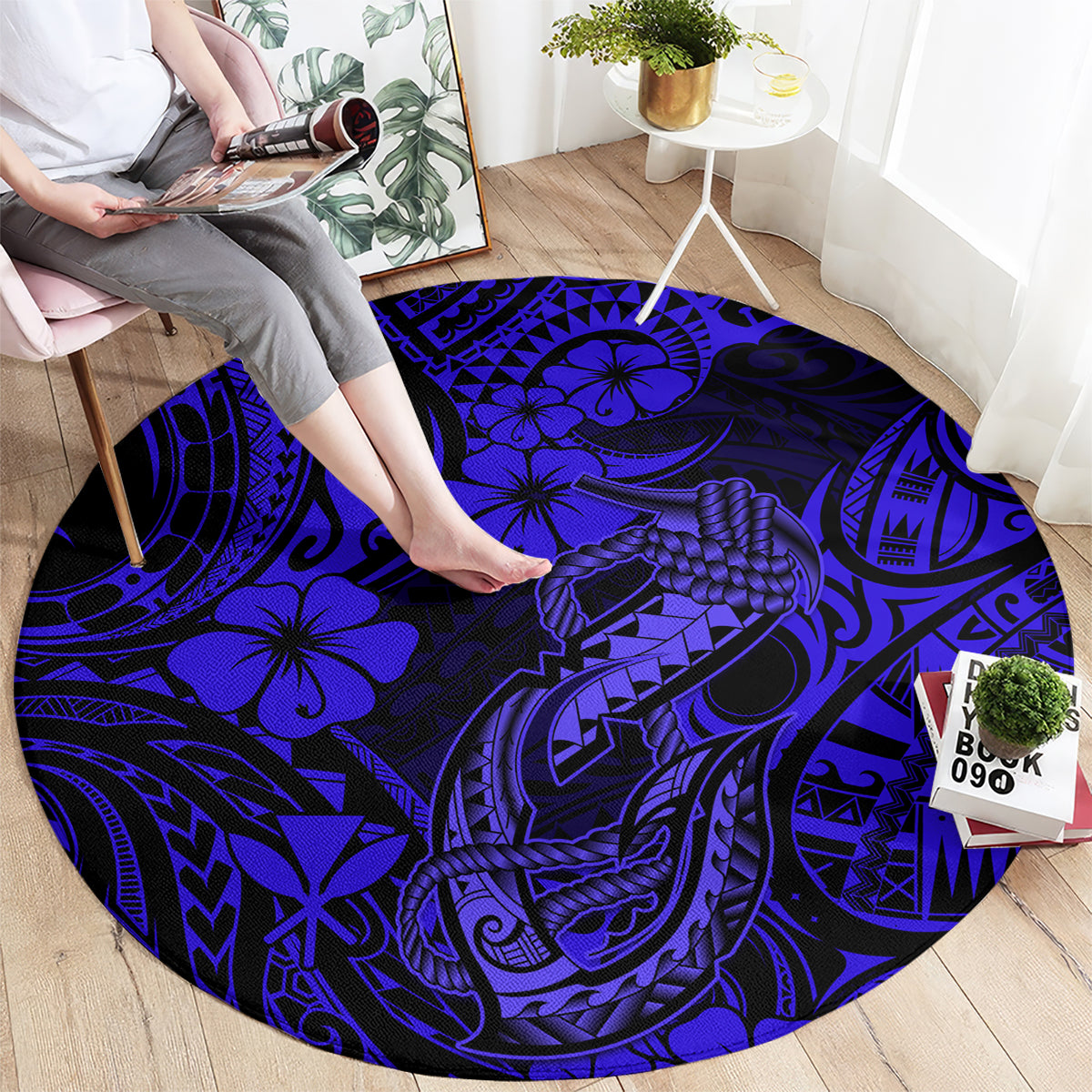 Round navy blue carpet with large polynesian fish-hook and floral motifs, full view