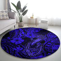Round navy blue tribal carpet with polynesian fish-hook patterns and flower shapes