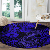 Round navy blue polynesian fish-hook patterned carpet with bold tribal swirls