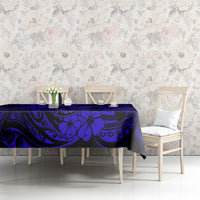 Navy blue tablecloth with Polynesian fish hook and floral motifs on dining table.